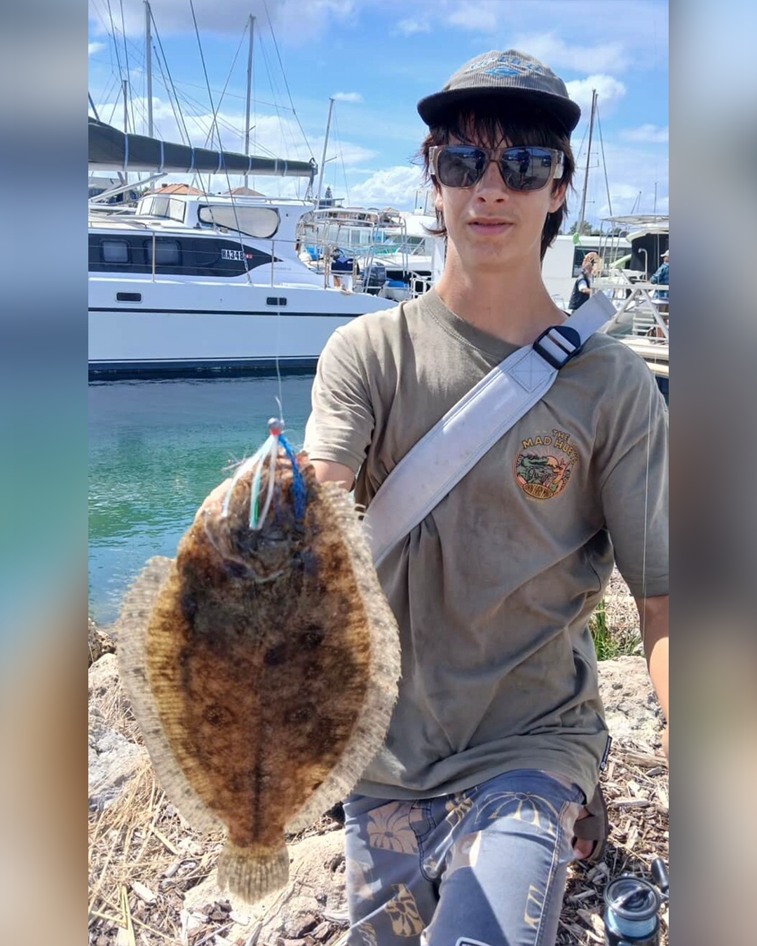 Angler Blaze holding large flathead flounder caught in local waters