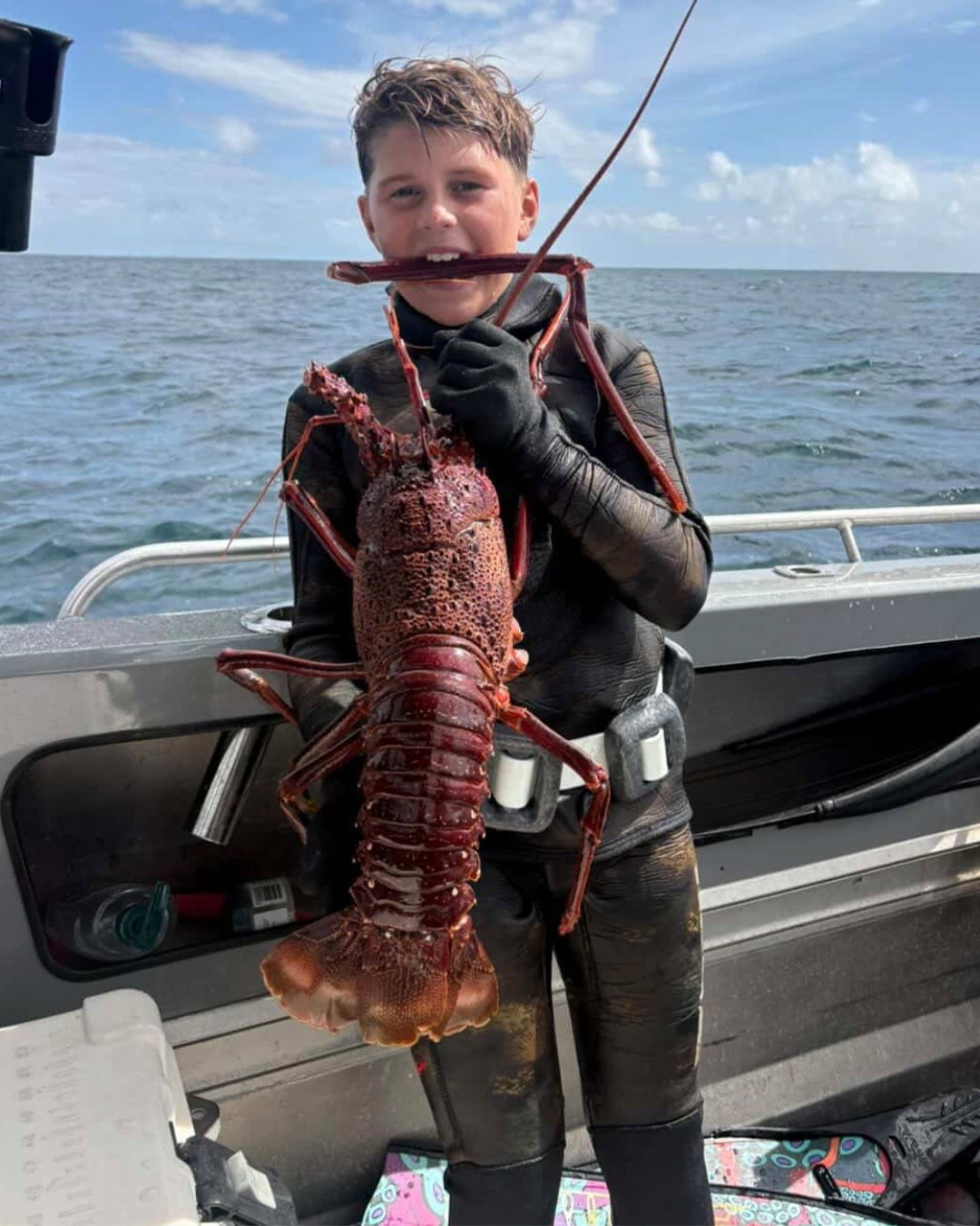 Mason proudly holding his first large crayfish catch from local waters