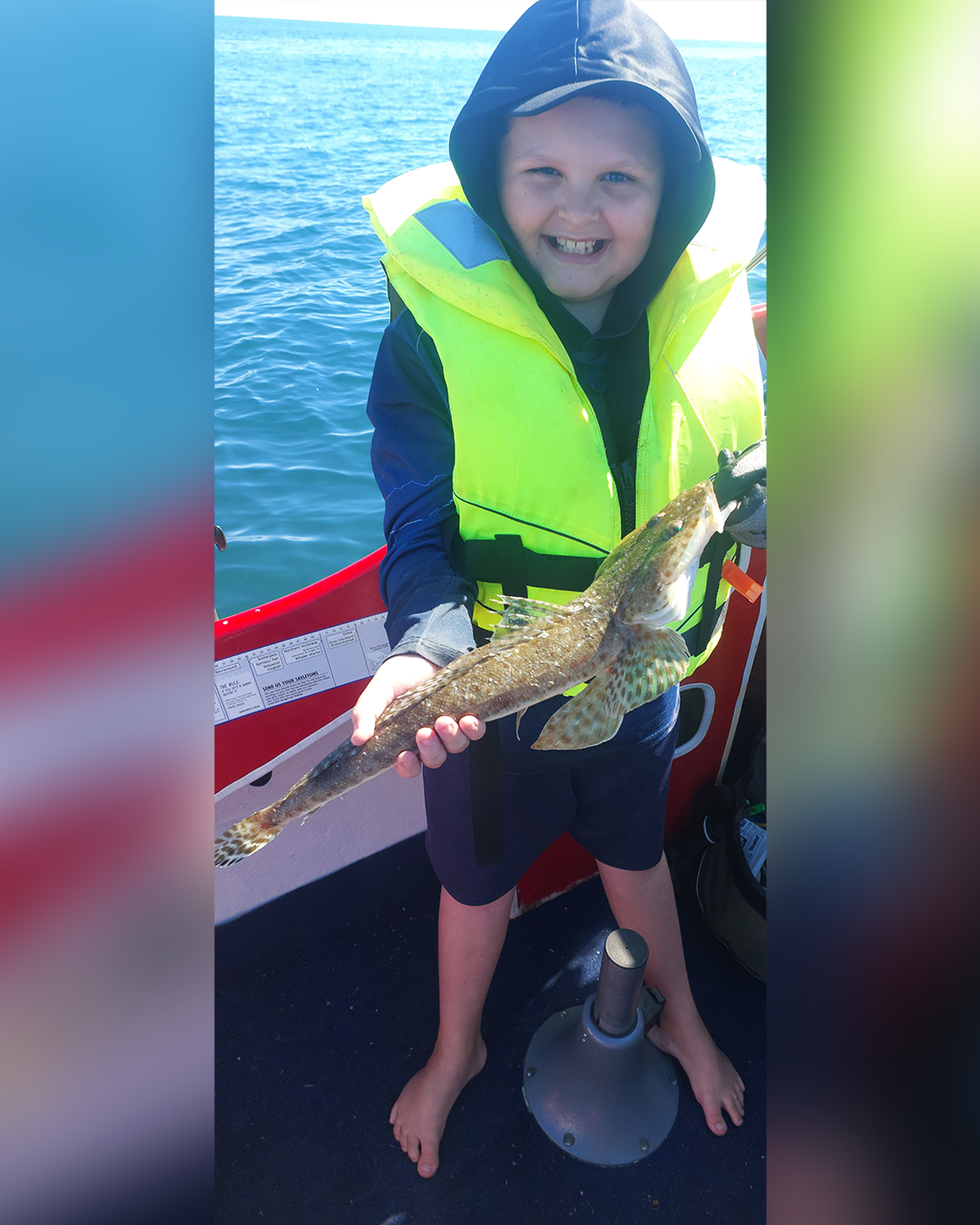 Proud angler holding 52cm flathead caught in local waters