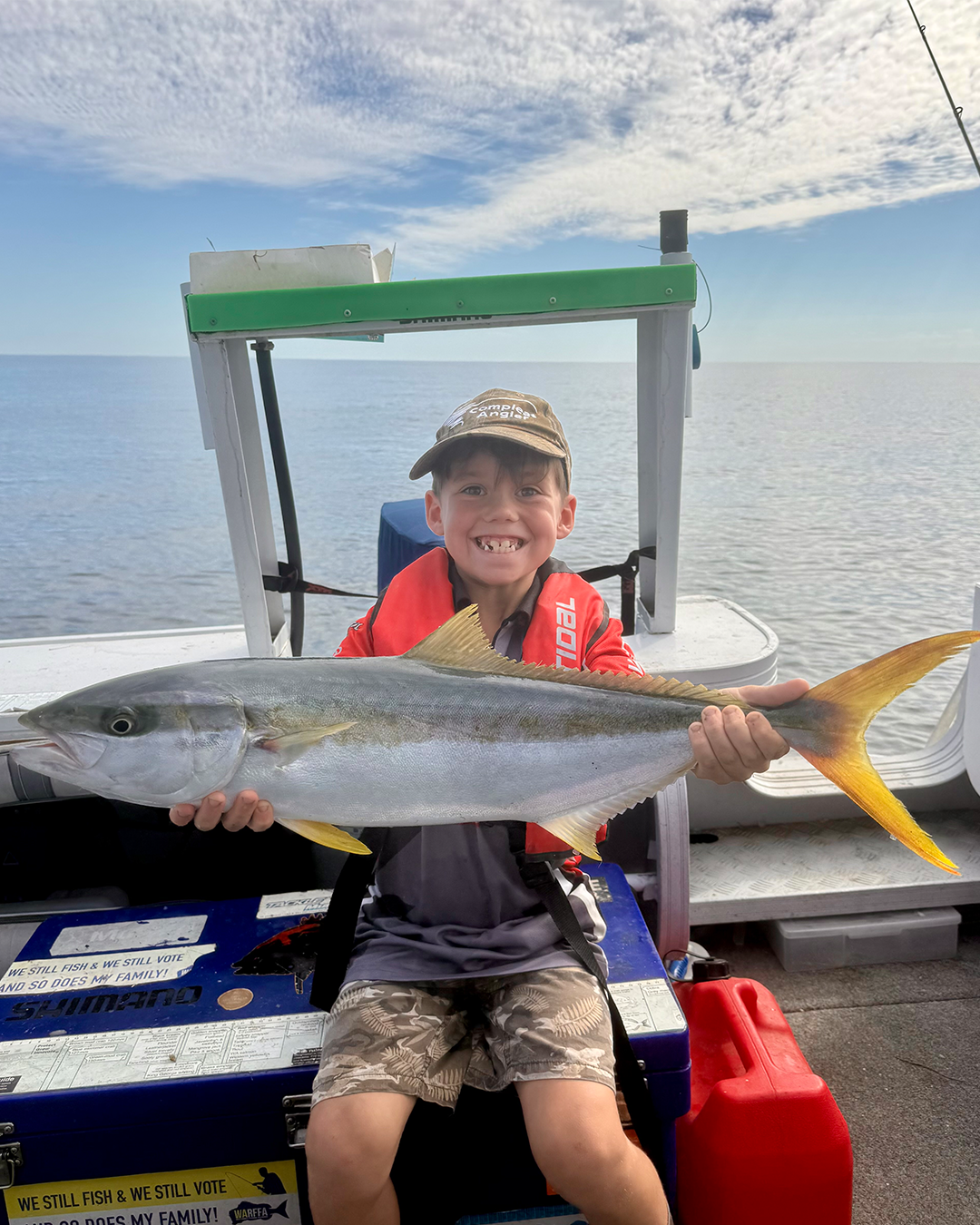 Angler holding yellowtail kingfish caught offshore from Mandurah