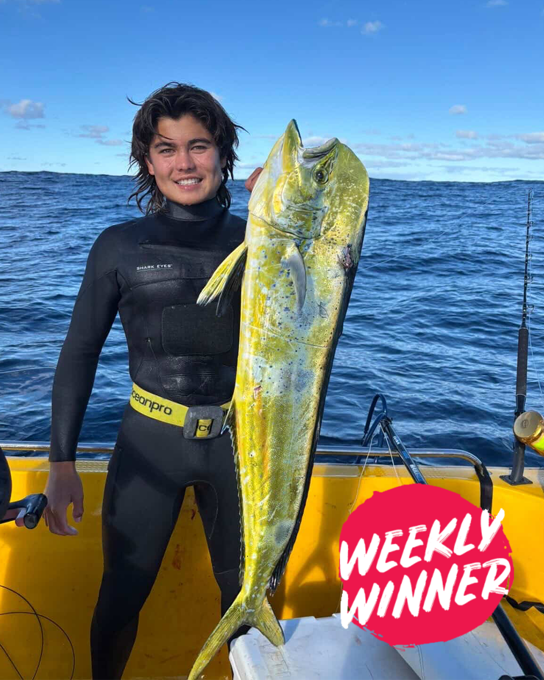 Angler holding dolphin fish caught while spearfishing in Mandurah waters