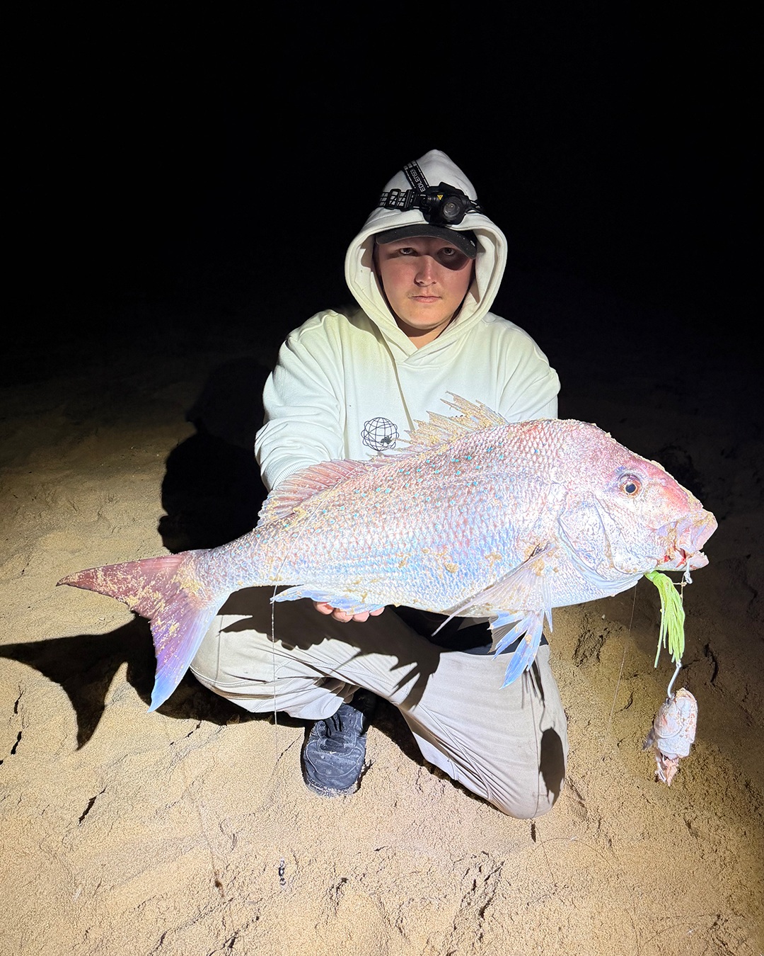 Angler Jake holding a snapper caught land-based at Mandurah