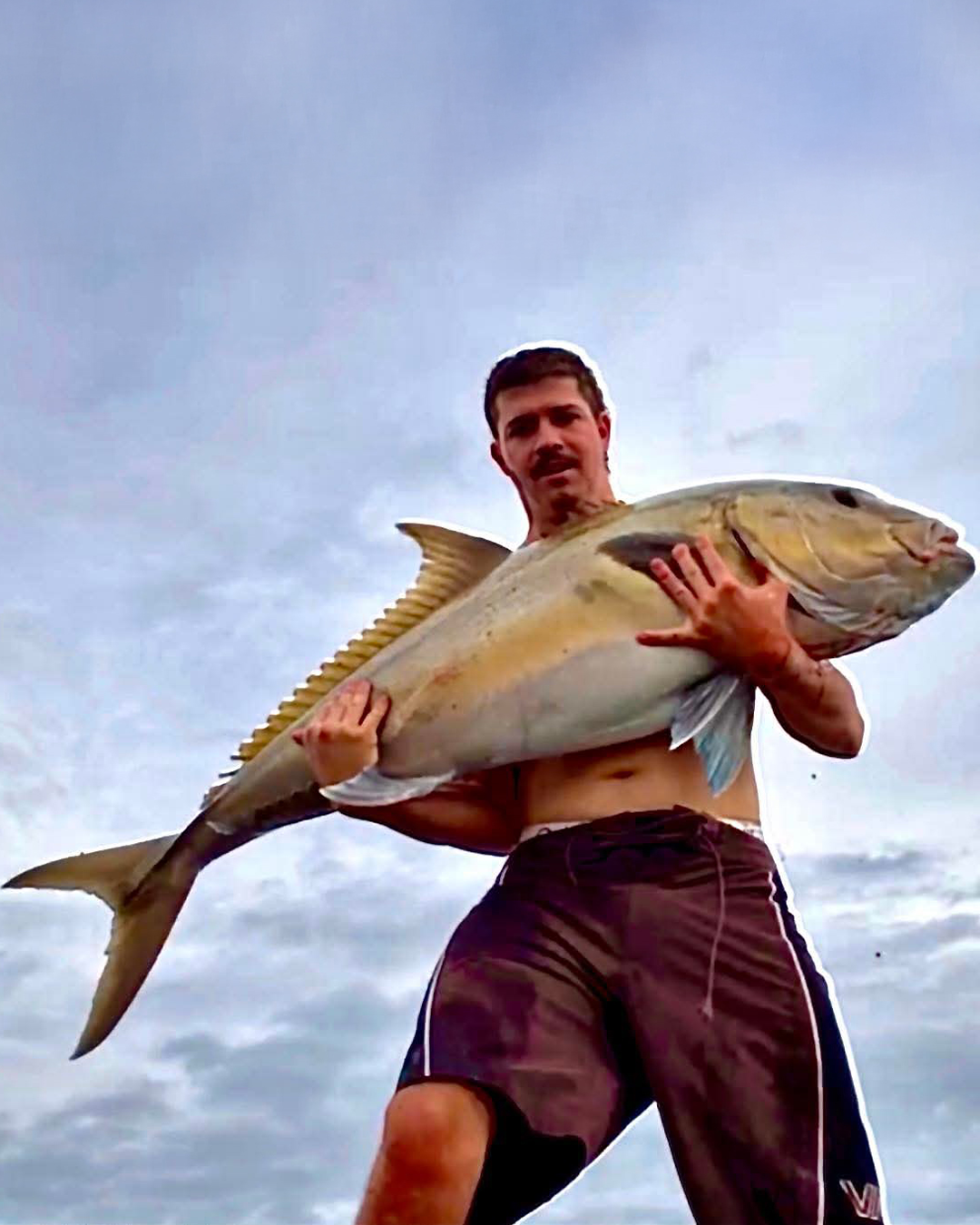 Angler holding a sambo caught in shallow water off Mandurah during winter