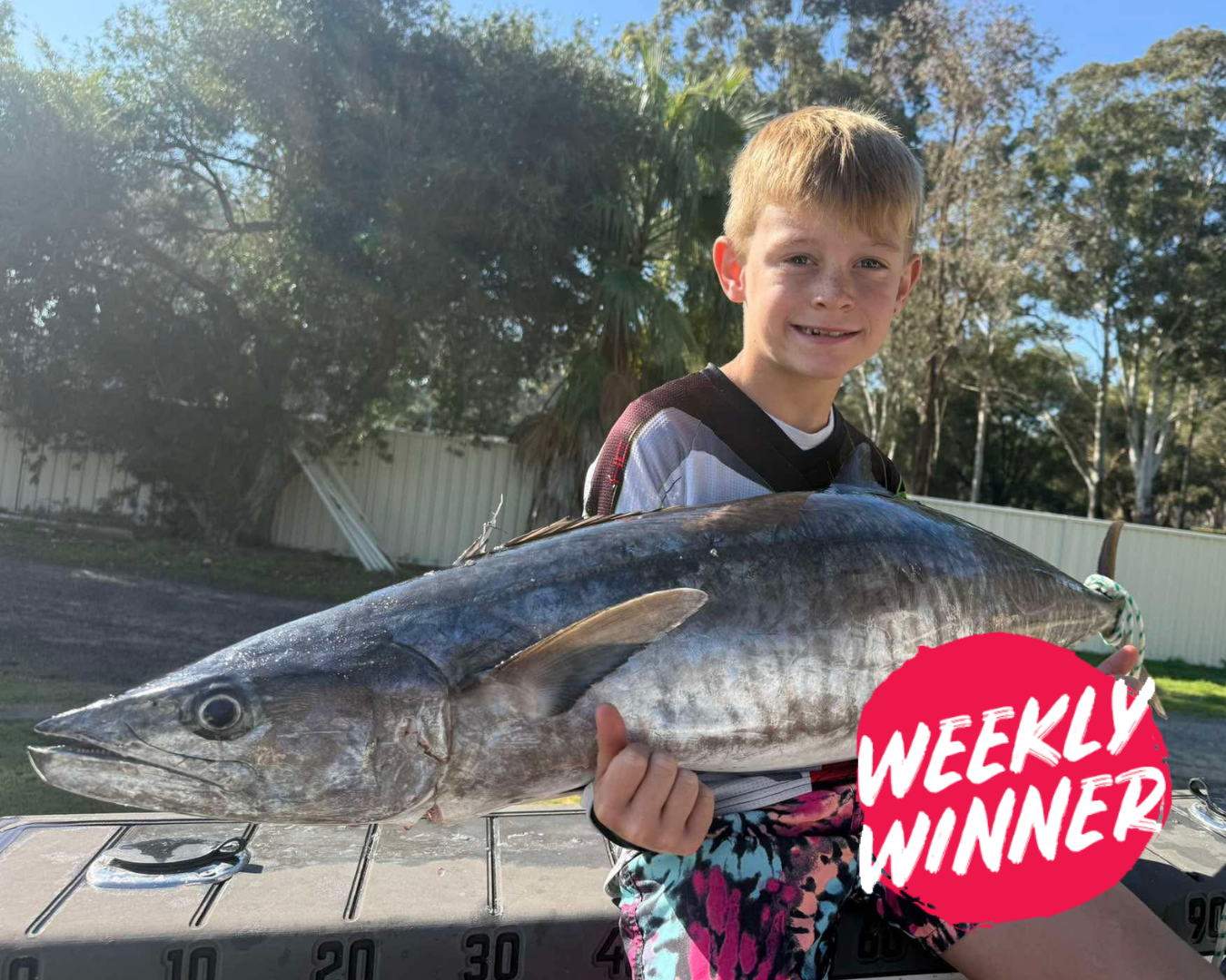 Young angler Oakly with father displaying winter mackerel caught offshore near Mandurah