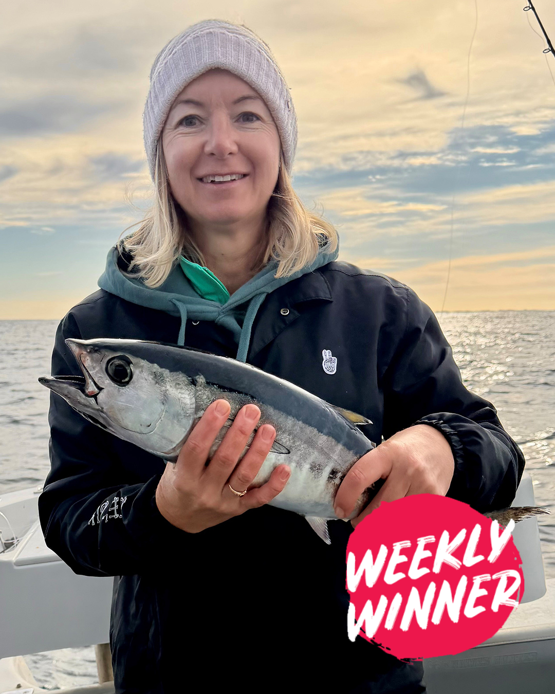 Angler holding fresh caught Blue Fin Tuna for sashimi preparation