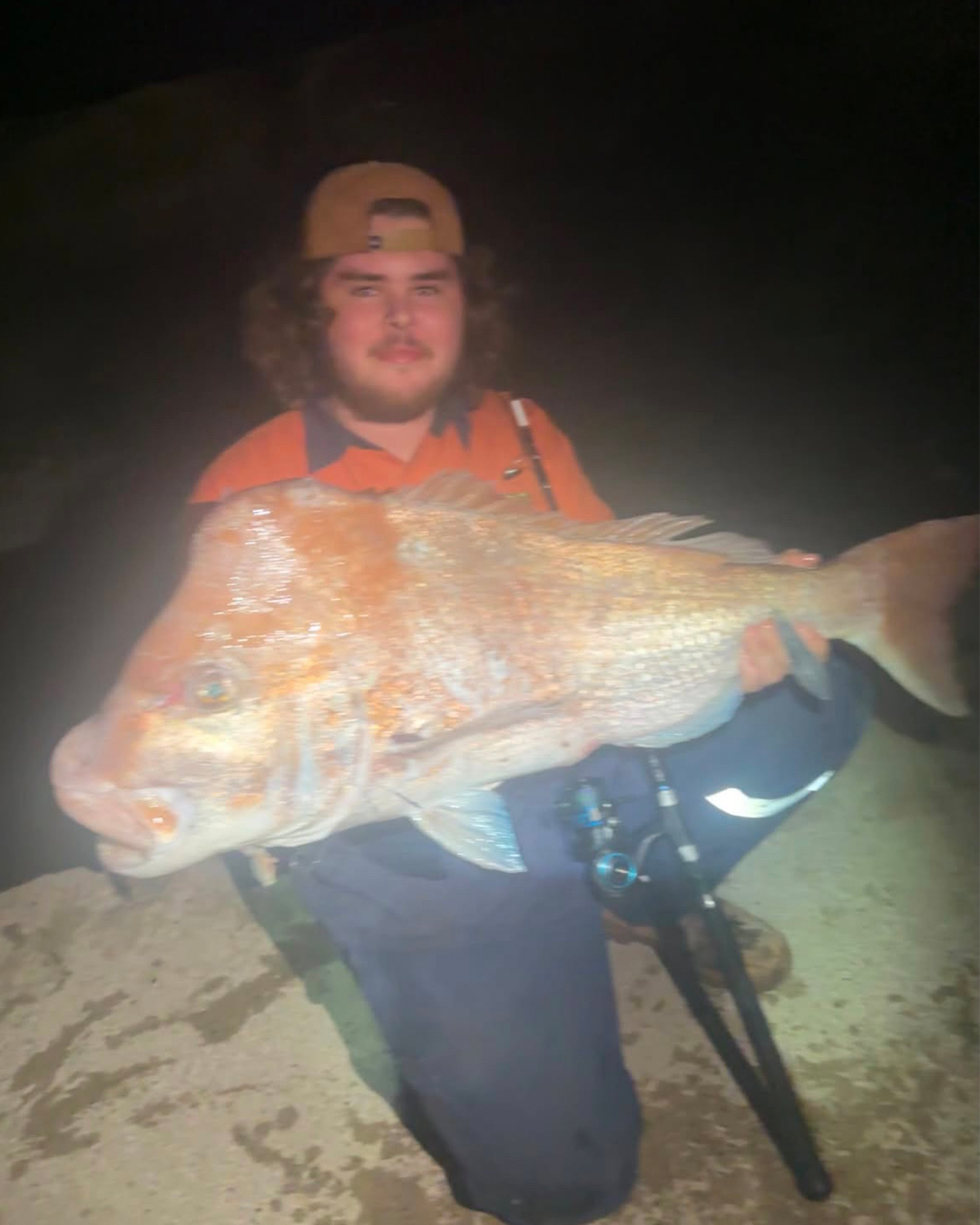 Angler Noah holding a humphead Pink Snapper caught from the beach near Mandurah