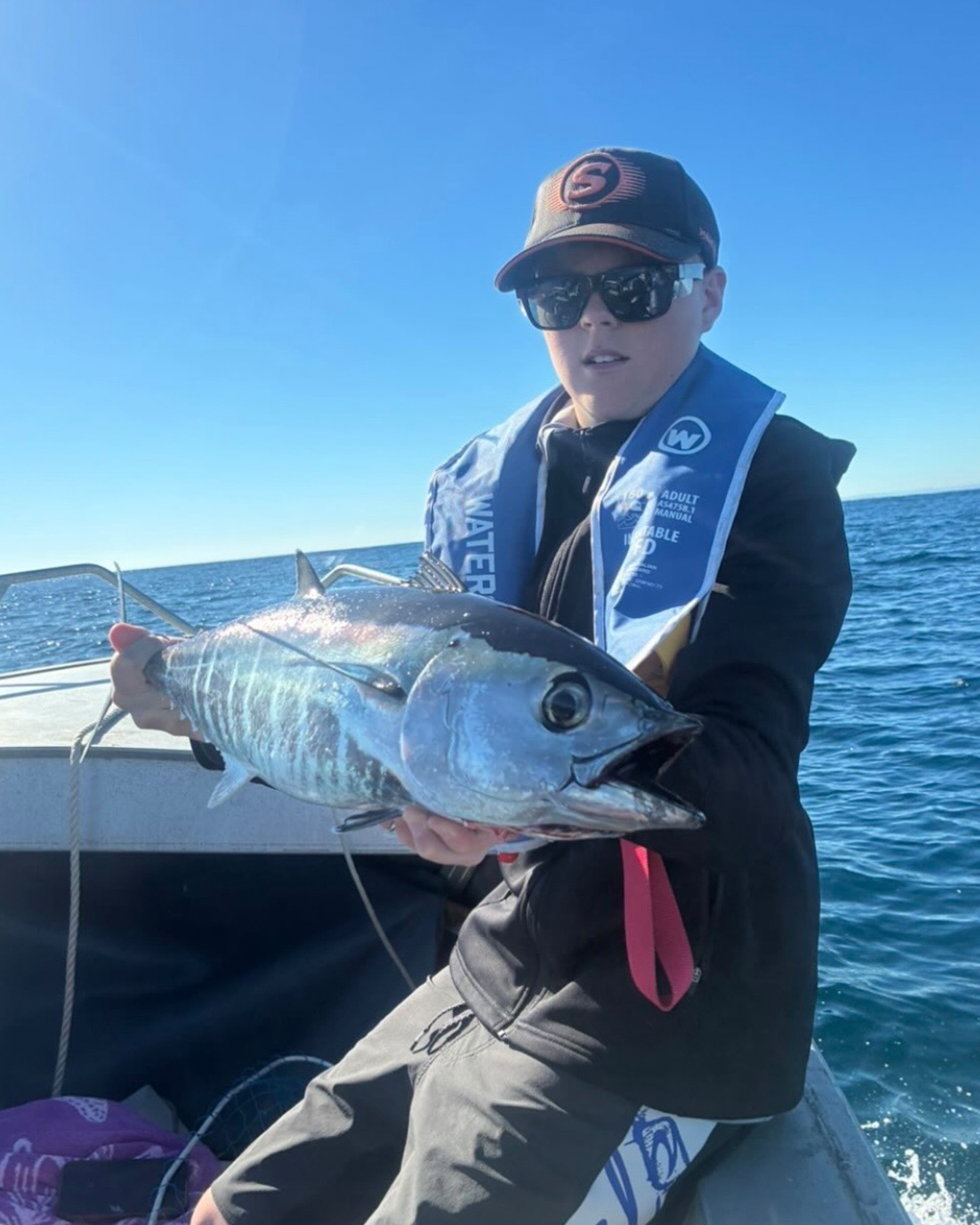 Angler Reeve with a pelagic fish caught under clear winter skies offshore Mandurah