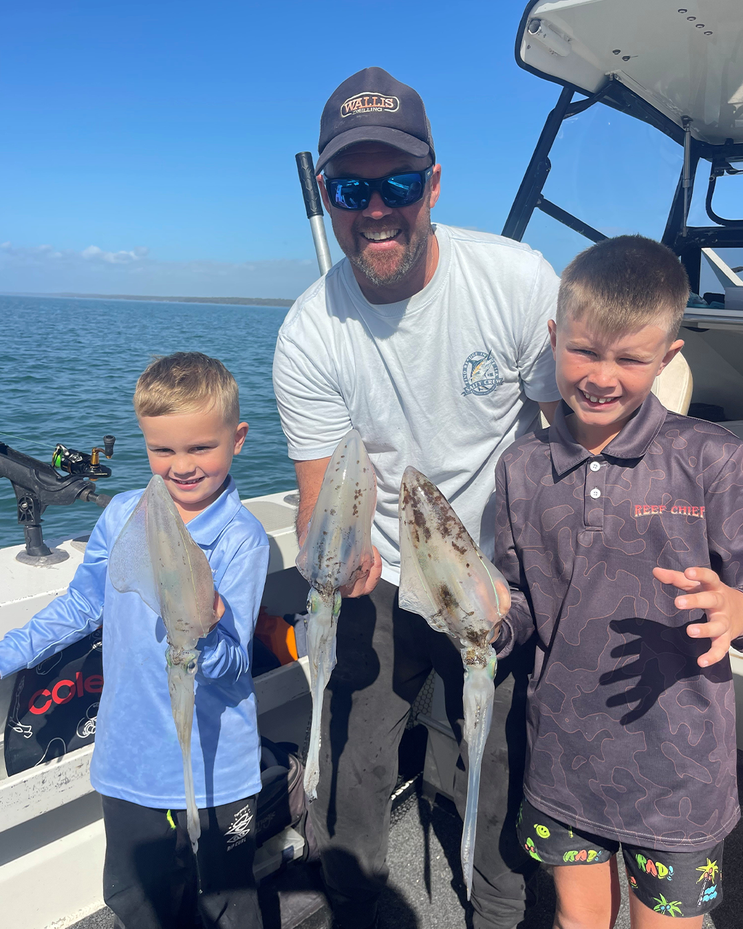 Family fishing trip in Mandurah with fresh squid catch and smiling faces on the water