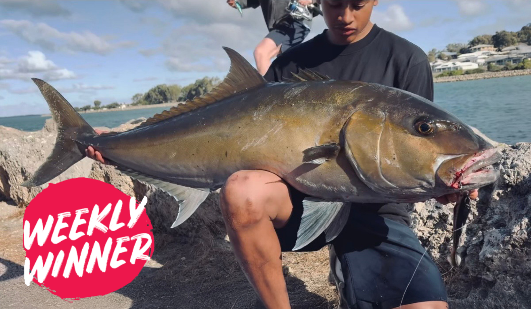 Angler Seth holding a large Samson fish caught in Mandurah winter waters