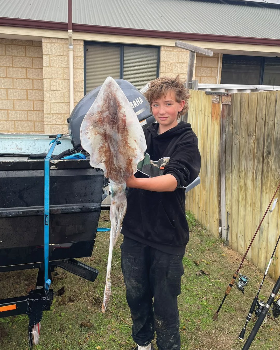Alex holding a large inshore squid caught in the Mandurah region during spring