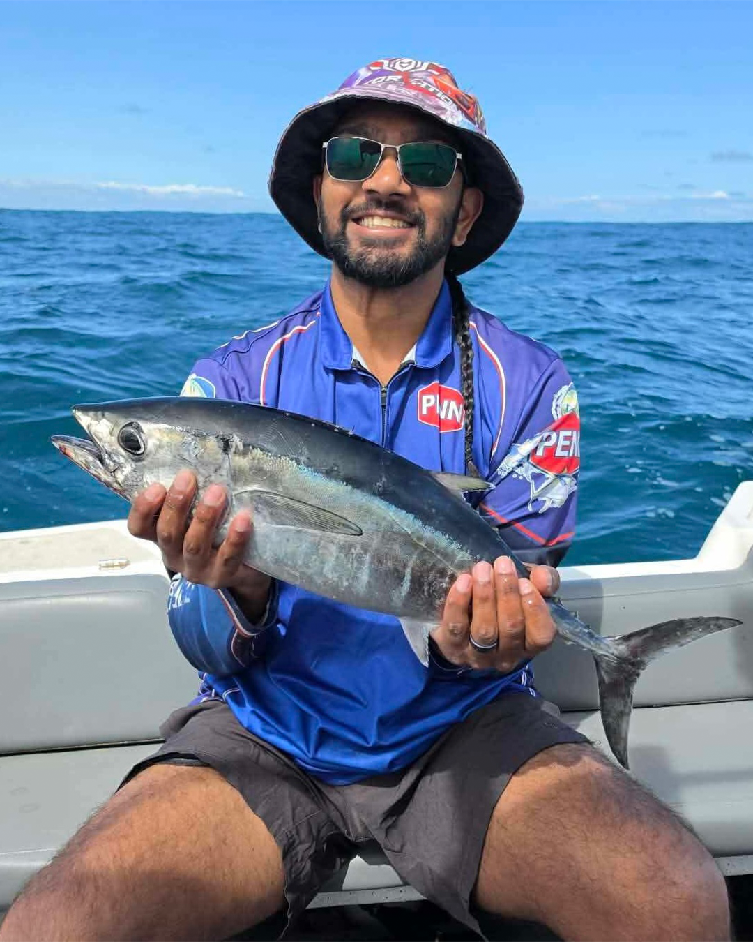 Angler Elwin holding a bluefin tuna caught from inshore waters near Mandurah