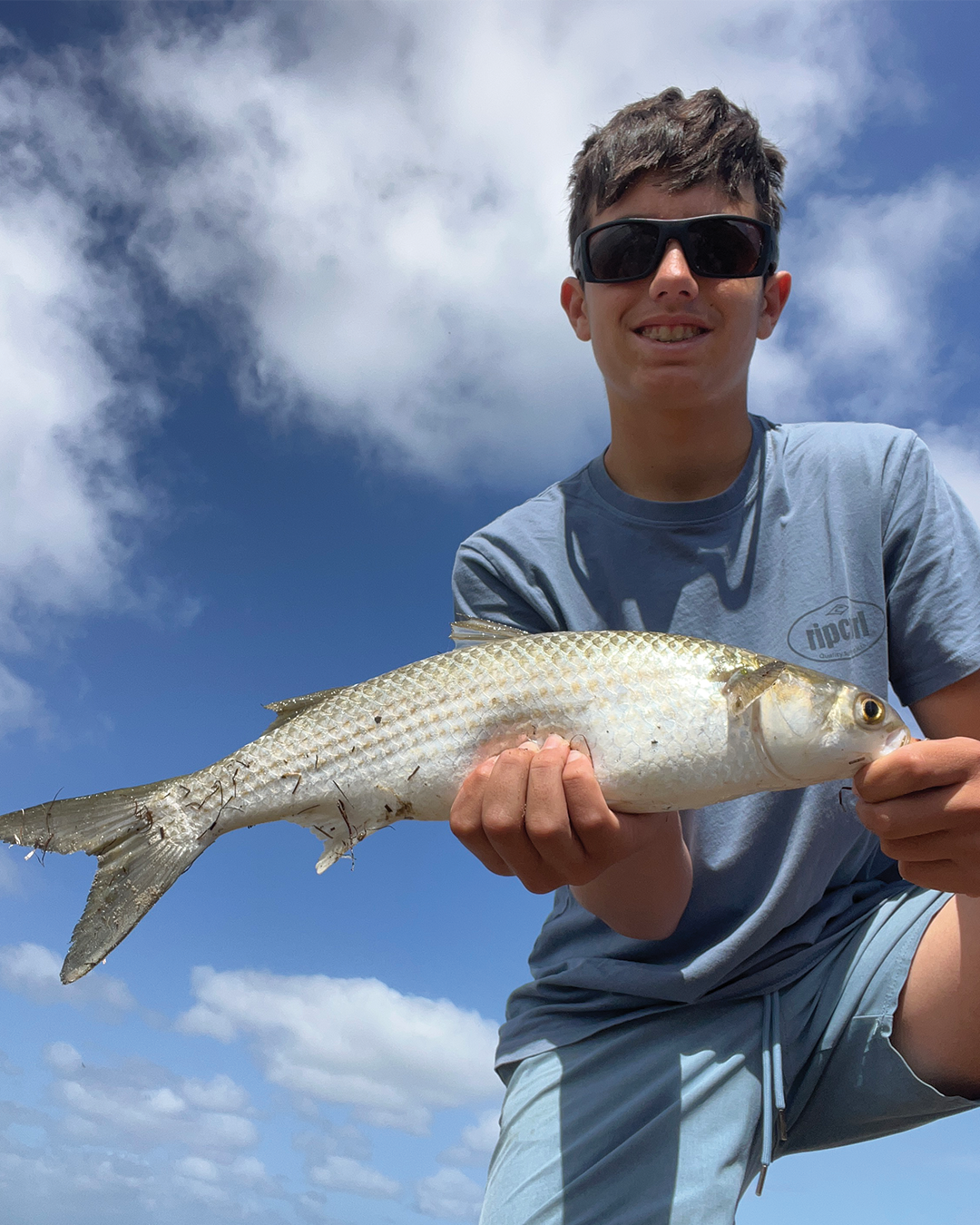 Angler Hayes presenting weed on a small hook to tempt mullet in a Mandurah waterway