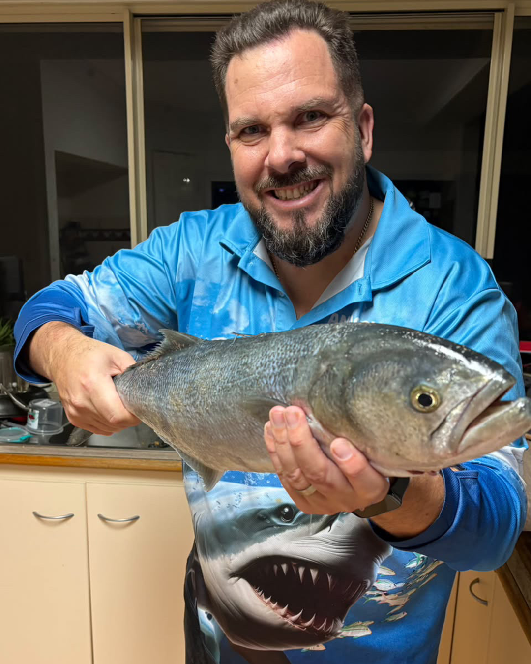 Angler James holding a large tailor caught land-based near Mandurah rock walls