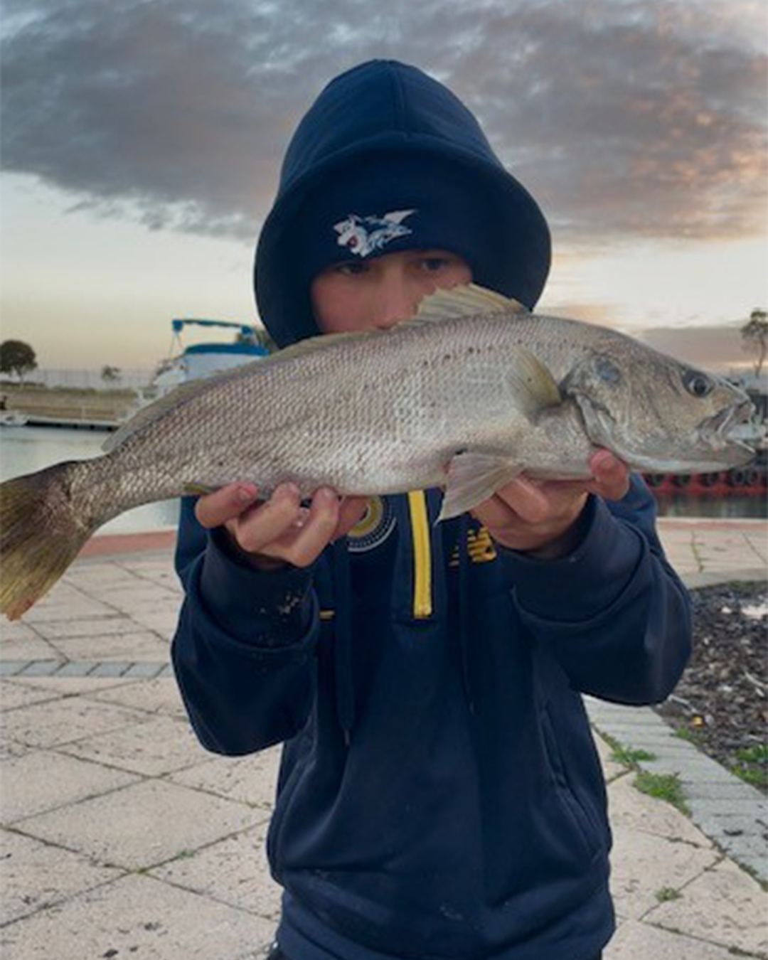 Angler Huddson holding a springtime mulloway caught in the Peel region estuary
