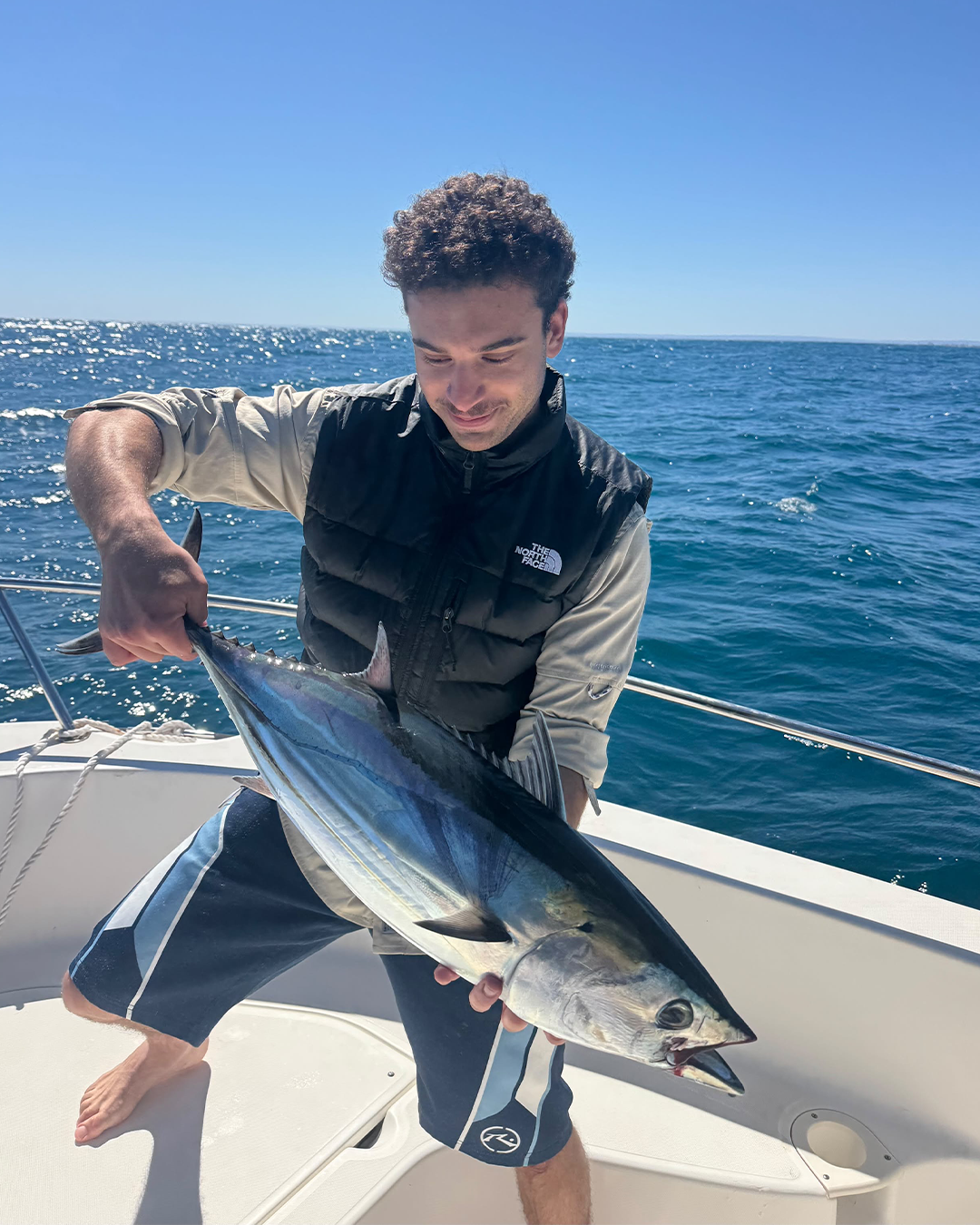 Angler James holding an inshore Striped Tuna or Skipjack Tuna caught near Mandurah