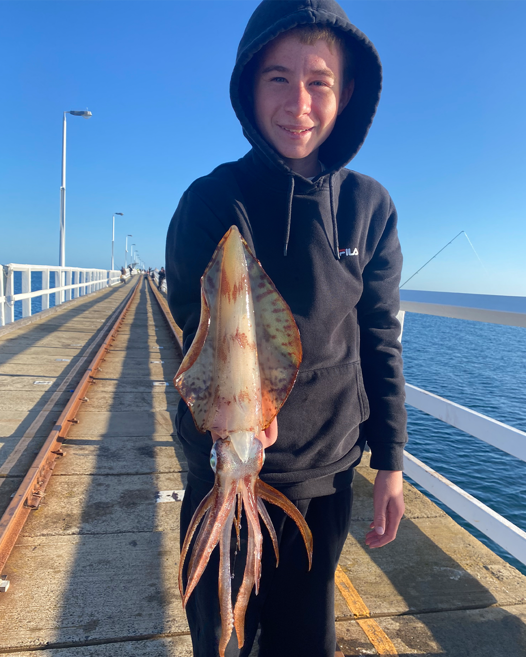 Angler Jordan holding a Squid caught land-based in Mandurah