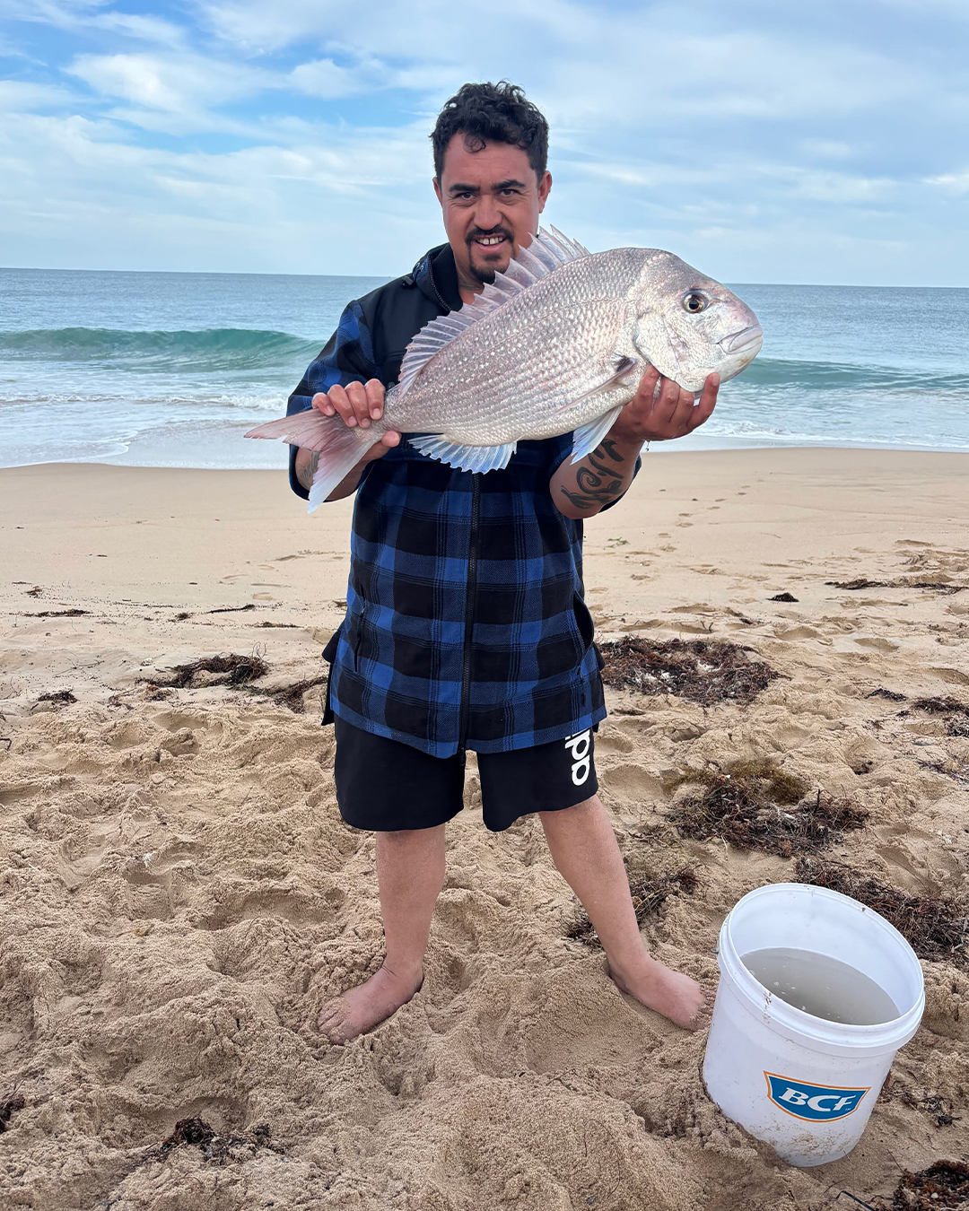 Angler Kurt holding his first land-based Snapper caught from the shore near Mandurah