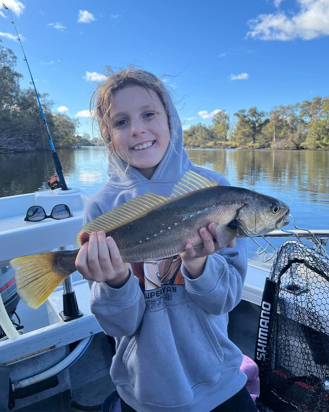 Angler Parker holding a juvenile Mulloway caught in the Mandurah river system