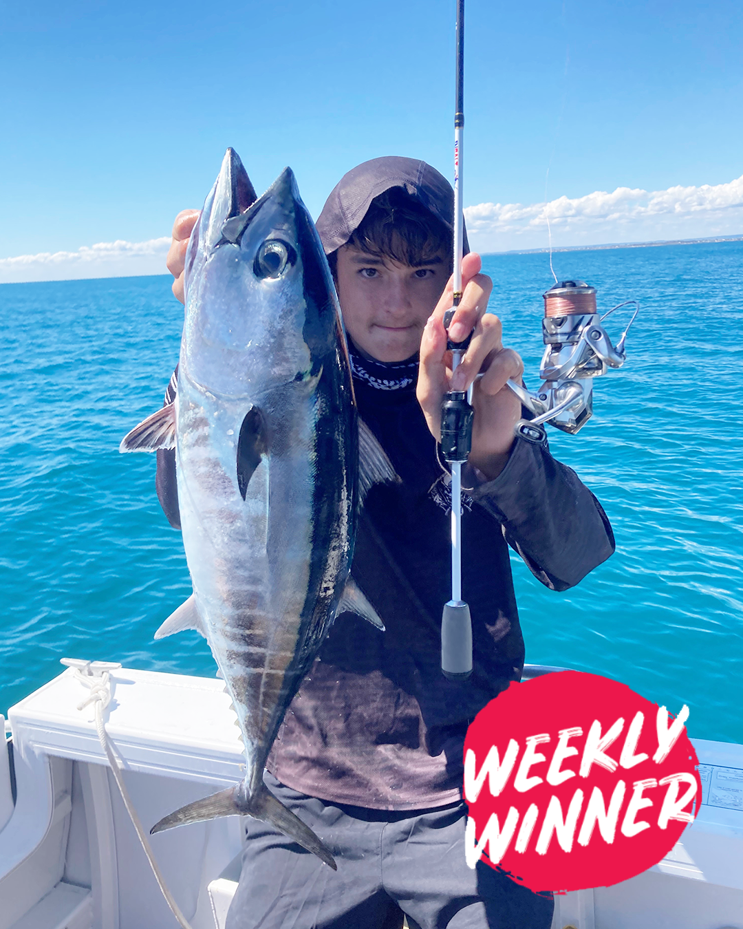 Angler Aiden holding a bluefin tuna caught inshore near Mandurah