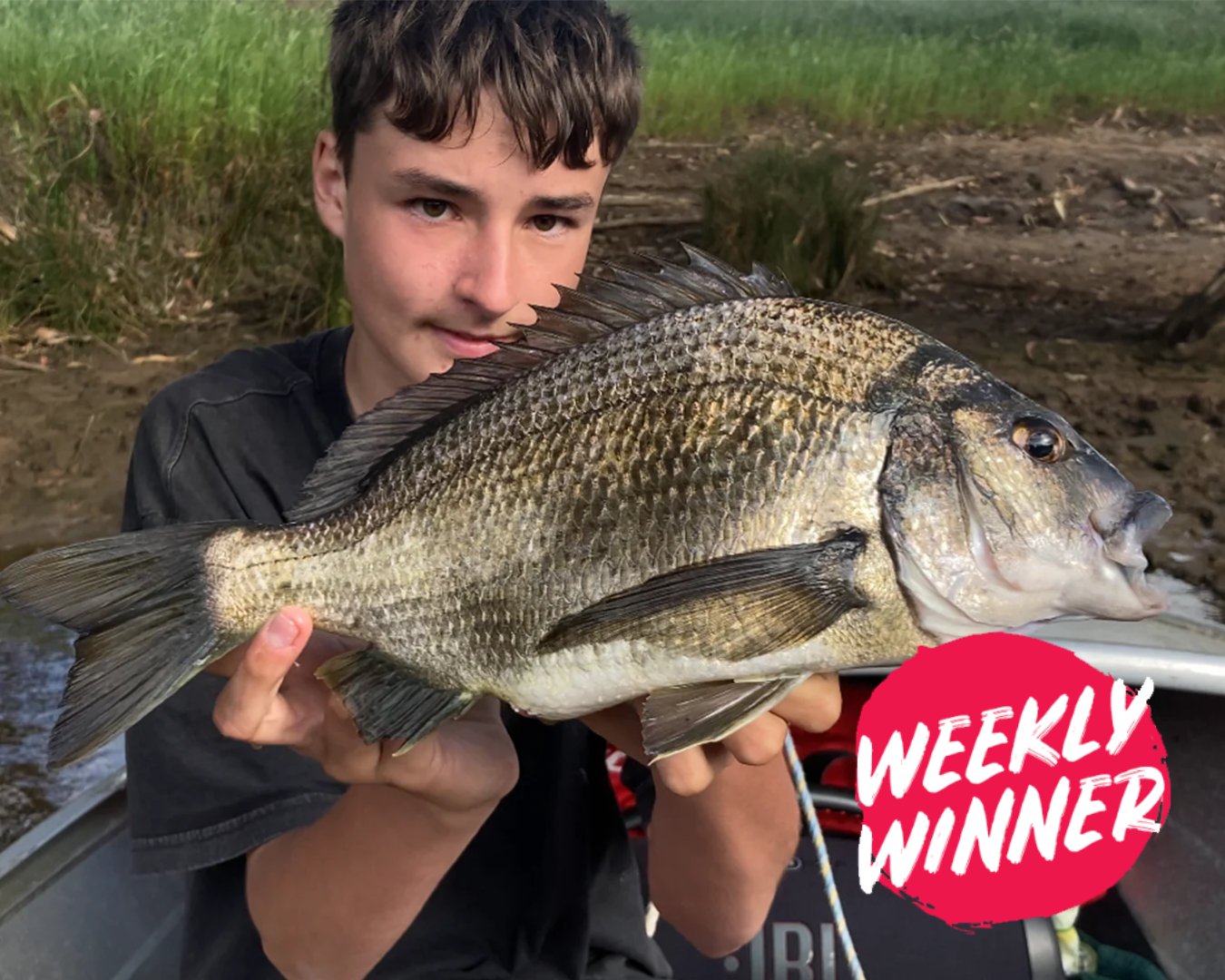 Angler Aiden holding a quality black bream close to 40cm caught in Mandurah waters