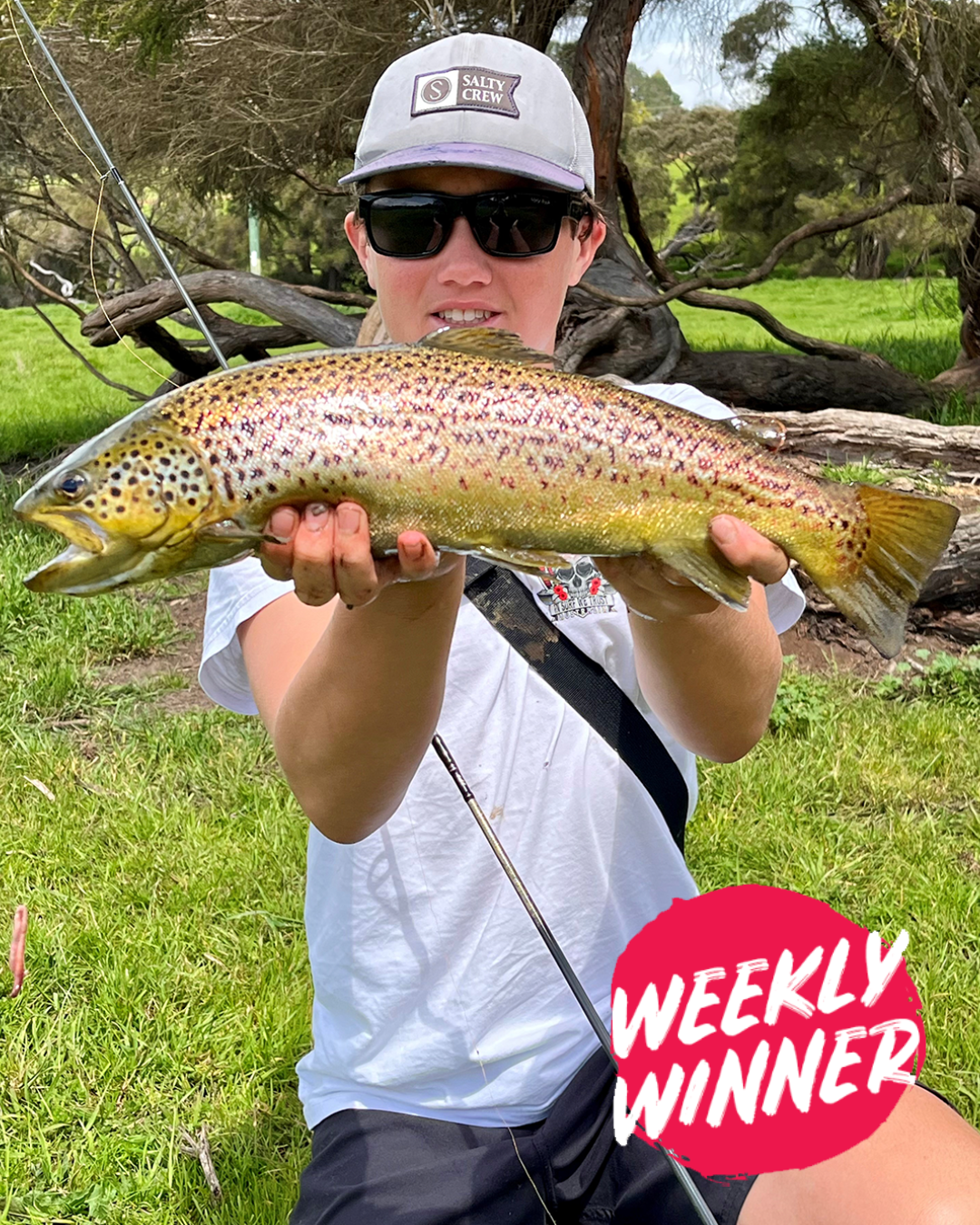 Angler Buzz proudly holding a large Brown Trout caught in the Peel region